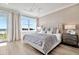 Main bedroom with a king-size bed and access to a balcony at 31879 Anchor Point Dr, Wesley Chapel, FL 33545