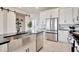 Modern kitchen with white cabinets, stainless steel appliances, and farmhouse sink at 31879 Anchor Point Dr, Wesley Chapel, FL 33545