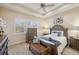 Well-lit bedroom featuring a comfortable bed and bench at 2632 Tarragona Way, Wesley Chapel, FL 33543