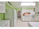 Galley kitchen with white cabinets and light green walls at 1511 Danbury Dr, Sun City Center, FL 33573