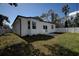 Back exterior view of the house showcasing a patio and fenced yard at 5549 97Th N Ter, Pinellas Park, FL 33782