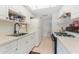 Full kitchen with white cabinets, gas range, and refrigerator at 1950 59Th N Ave # 318, St Petersburg, FL 33714