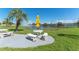 Peaceful lakefront patio with table and benches at 1950 59Th N Ave # 318, St Petersburg, FL 33714