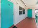 Teal colored front door and hallway access to unit at 1950 59Th N Ave # 318, St Petersburg, FL 33714