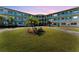 Evening exterior view of mid-century modern building with landscaping at 1950 59Th N Ave # 318, St Petersburg, FL 33714
