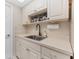 Kitchen features a clean sink and white cabinets at 1950 59Th N Ave # 318, St Petersburg, FL 33714