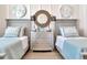 Twin bedroom with light blue bedding and plenty of natural light at 31885 Anchor Point Dr, Wesley Chapel, FL 33545
