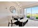 Dining room with a modern table, white chairs, and access to a patio at 31885 Anchor Point Dr, Wesley Chapel, FL 33545