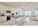 Open concept kitchen with white cabinets, large island, and stainless steel appliances at 31885 Anchor Point Dr, Wesley Chapel, FL 33545