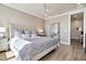 Spacious main bedroom with a large bed, full-length mirror, and plenty of light at 31885 Anchor Point Dr, Wesley Chapel, FL 33545