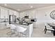 Modern kitchen featuring white cabinets, a large kitchen island with seating, and marble flooring at 31885 Anchor Point Dr, Wesley Chapel, FL 33545