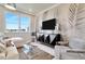 Bright living room features a comfortable sofa, large TV, and stylish wall decor at 31885 Anchor Point Dr, Wesley Chapel, FL 33545
