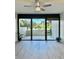 Living room with sliding doors leading to a private patio and water view at 400 Island Way # 103, Clearwater Beach, FL 33767