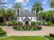 Grand two-story home with circular driveway and lush landscaping at 6211 Emmons Ln, Tampa, FL 33647