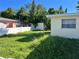Large backyard with overgrown grass at 5323 Carlton Rd, New Port Richey, FL 34652