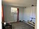 Simple bedroom with window, wall damage, and laminate flooring at 5323 Carlton Rd, New Port Richey, FL 34652