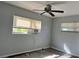 Simple bedroom with window and ceiling fan at 5323 Carlton Rd, New Port Richey, FL 34652