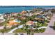 An aerial view of a house with a meticulously maintained lawn, lush landscaping, and a circular driveway at 165 4Th N Ave, Tierra Verde, FL 33715