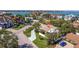 Aerial view of coastal home featuring lush landscaping and a tile roof at 165 4Th N Ave, Tierra Verde, FL 33715