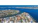 A neighborhood situated on the water featuring numerous homes with docks and boats at 165 4Th N Ave, Tierra Verde, FL 33715