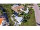 A private residence with a sprawling driveway, mature trees, and manicured landscaping at 165 4Th N Ave, Tierra Verde, FL 33715