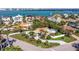 Aerial view of waterfront home with lush greenery, screened-in porch, and convenient access to the bay at 165 4Th N Ave, Tierra Verde, FL 33715