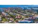 An aerial perspective reveals a vibrant neighborhood with lush trees, well-kept lawns, and convenient street access at 165 4Th N Ave, Tierra Verde, FL 33715