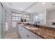 Bright bathroom with marble walls, granite countertop, modern fixtures and a large mirror at 165 4Th N Ave, Tierra Verde, FL 33715