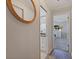 Bathroom featuring white cabinetry, granite countertop, a framed mirror and a glass-door shower at 165 4Th N Ave, Tierra Verde, FL 33715