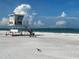 A beautiful beach featuring soft sand and clear turquoise waters, with a lifeguard tower at 165 4Th N Ave, Tierra Verde, FL 33715
