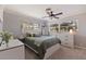 Cozy bedroom with a ceiling fan, dresser, and natural light from the window with wooden blinds at 165 4Th N Ave, Tierra Verde, FL 33715