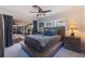 Bedroom featuring platform bed with sliding glass doors to the outdoor patio with fan and lounge at 165 4Th N Ave, Tierra Verde, FL 33715