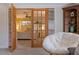 Comfortable reading nook with bedroom view through glass paneled doors at 165 4Th N Ave, Tierra Verde, FL 33715