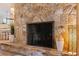 Close up of a stone fireplace providing warmth and charm to the home's interior at 165 4Th N Ave, Tierra Verde, FL 33715
