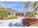 Inviting home with a well-manicured front yard, beautiful stone accents, and a charming front porch at 165 4Th N Ave, Tierra Verde, FL 33715