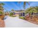 Charming home featuring a stone facade, well-manicured landscaping, and a bright blue front door at 165 4Th N Ave, Tierra Verde, FL 33715