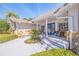 Inviting front porch with rocking chairs and charming blue double doors at 165 4Th N Ave, Tierra Verde, FL 33715