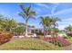 Inviting single story home featuring lush landscaping, mature palms, and a welcoming front entrance at 165 4Th N Ave, Tierra Verde, FL 33715