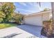 Spacious two-car garage with a clean driveway, surrounded by well-maintained landscaping for added privacy at 165 4Th N Ave, Tierra Verde, FL 33715
