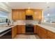 Spacious kitchen with ample wood cabinets, marble countertops, and stainless steel oven and microwave at 165 4Th N Ave, Tierra Verde, FL 33715