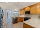 Kitchen featuring stainless steel appliances, wood cabinets, and views into another living space at 165 4Th N Ave, Tierra Verde, FL 33715