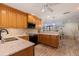 Updated kitchen boasts marble counters, wooden cabinets, stainless sink, and modern appliances at 165 4Th N Ave, Tierra Verde, FL 33715