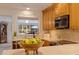 Bright kitchen features marble counters, wooden cabinets, stainless appliances and breakfast bar at 165 4Th N Ave, Tierra Verde, FL 33715