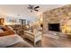 Cozy living room featuring a stone fireplace, comfortable seating, and a ceiling fan at 165 4Th N Ave, Tierra Verde, FL 33715