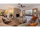 Inviting living room features stone fireplace, wood floors, ceiling fan and neutral decor at 165 4Th N Ave, Tierra Verde, FL 33715