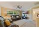 Comfortable living room with neutral-toned walls, a ceiling fan, and a sunset view through the window at 165 4Th N Ave, Tierra Verde, FL 33715