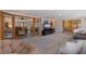 Spacious living room featuring carpet, glass paneled doors, and comfortable seating at 165 4Th N Ave, Tierra Verde, FL 33715