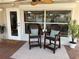 Charming patio space with stylish chairs, neutral rug, ceiling fan, and serene outdoor view at 165 4Th N Ave, Tierra Verde, FL 33715