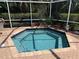 Enjoy a refreshing screened-in pool and patio surrounded by lush landscaping perfect for outdoor relaxation at 165 4Th N Ave, Tierra Verde, FL 33715