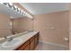 Spacious bathroom featuring double sinks, a large mirror, and bright lighting at 2857 Brewster Rd, North Port, FL 34288